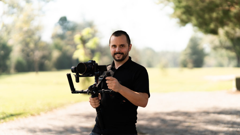 Dalton Young Destination Wedding Videographer Holding Camera